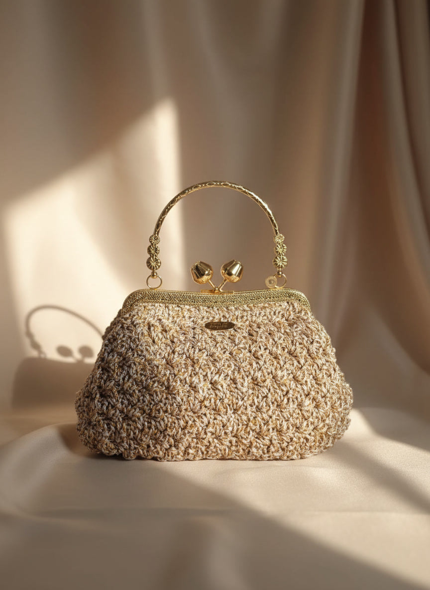Handmade beige crochet handbag with elegant gold metal frame by Chainettes