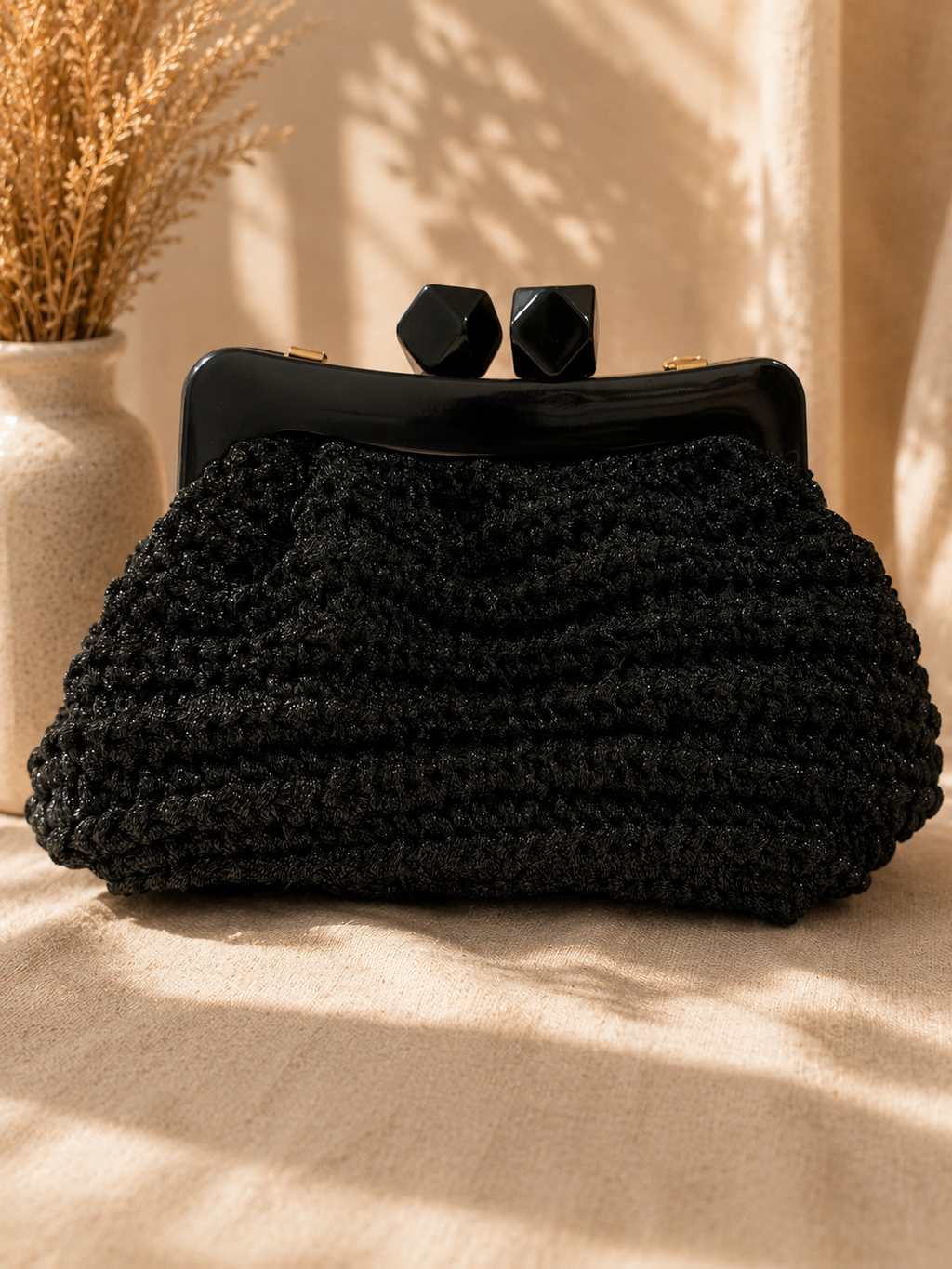 Black crochet clutch with geometric acrylic frame by Chainettes
