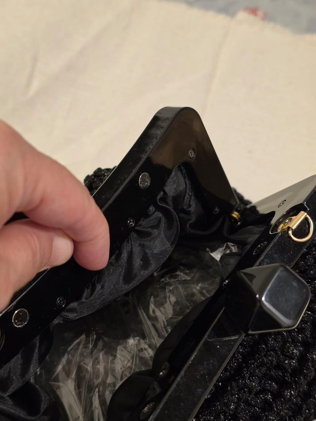 Black satin lining inside handmade crochet clutch