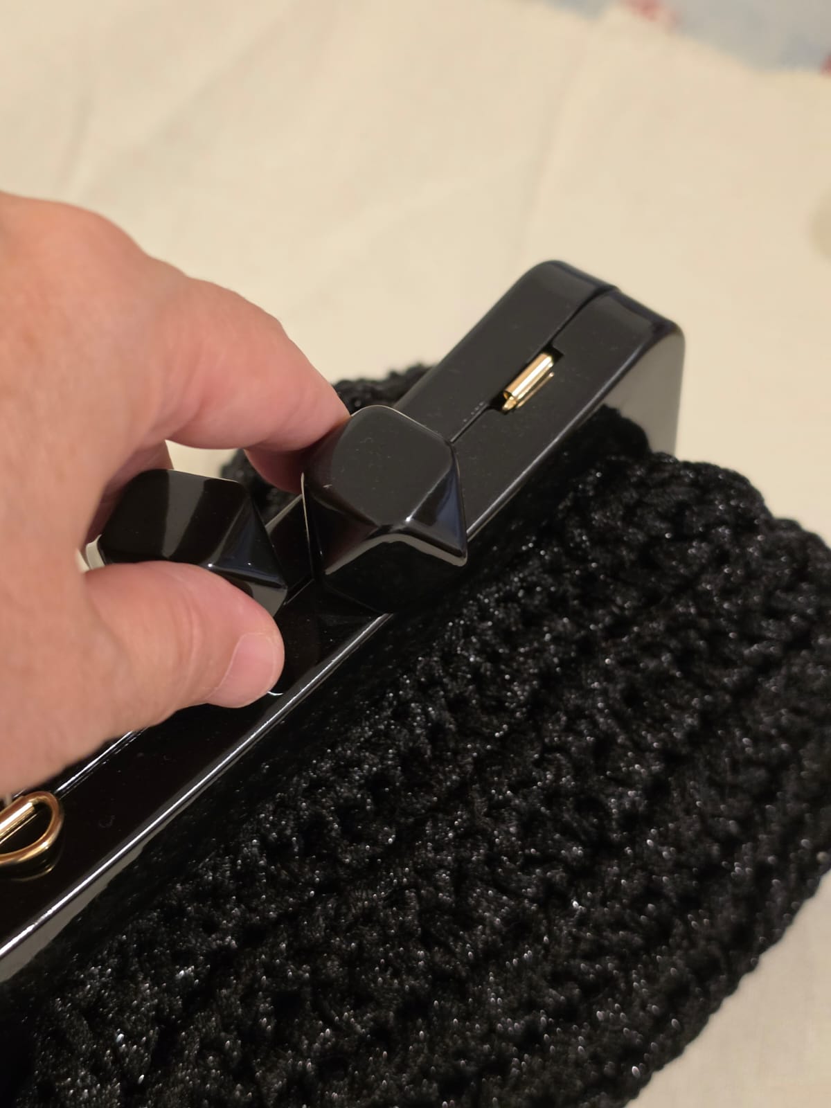 Faceted clasp detail on Noir Facet black crochet clutch