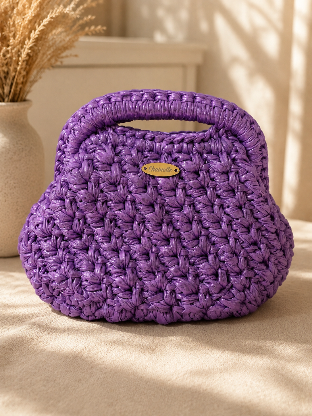 Purple handmade metallic leather bag with integrated handle and magic frame closure